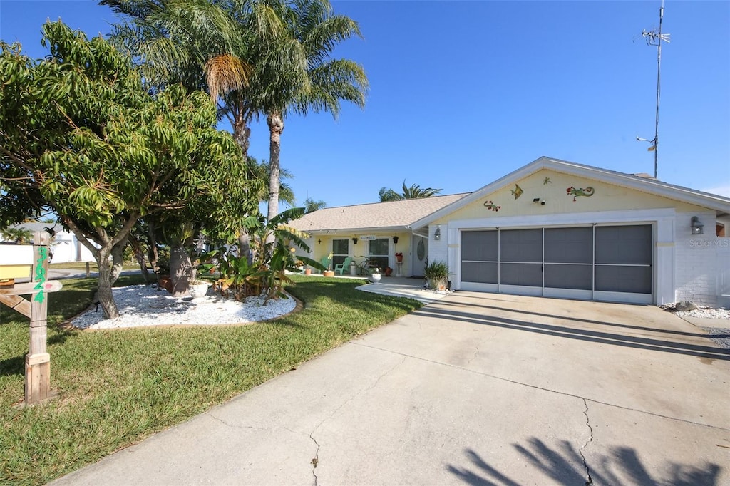 single story home featuring a front lawn and a garage