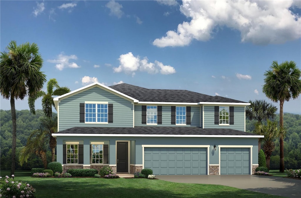 view of front of property with a front yard and a garage