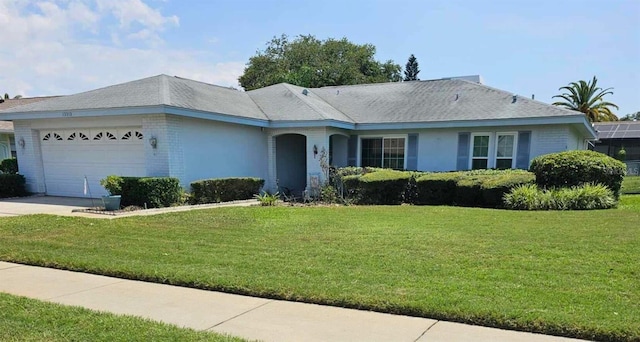 single story home featuring a front yard and a garage