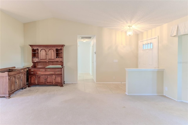 carpeted empty room featuring lofted ceiling