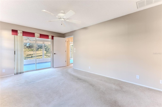 carpeted spare room with ceiling fan