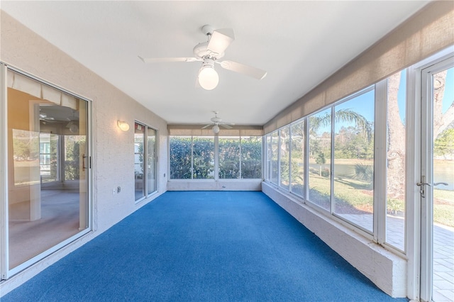 unfurnished sunroom with ceiling fan