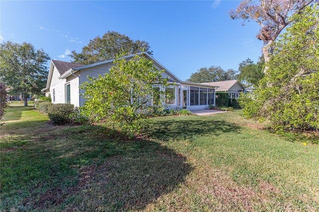 back of property featuring a lawn and a patio