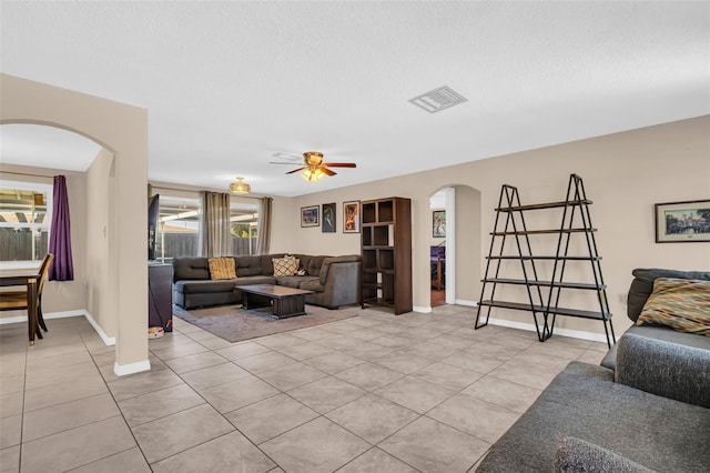 living room with ceiling fan and light tile patterned flooring