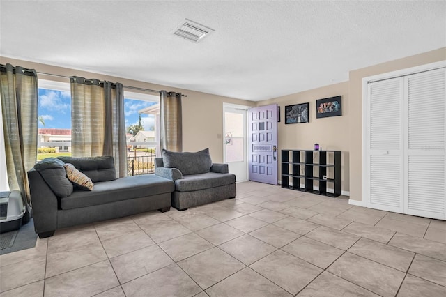 tiled living room with a textured ceiling