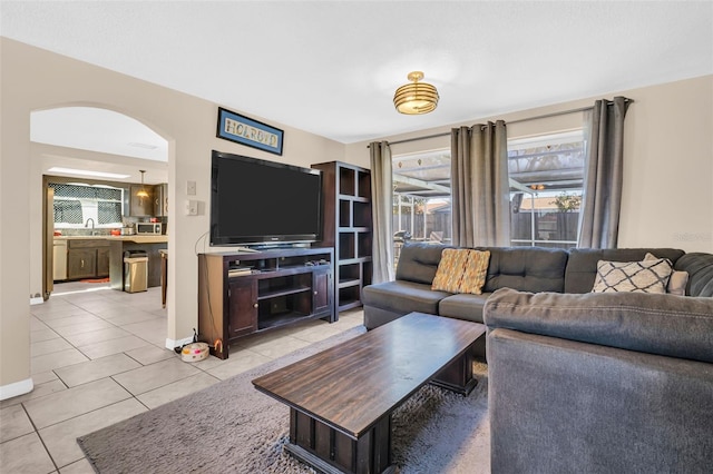 tiled living room featuring sink