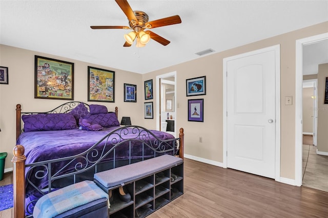 bedroom with ceiling fan and hardwood / wood-style flooring