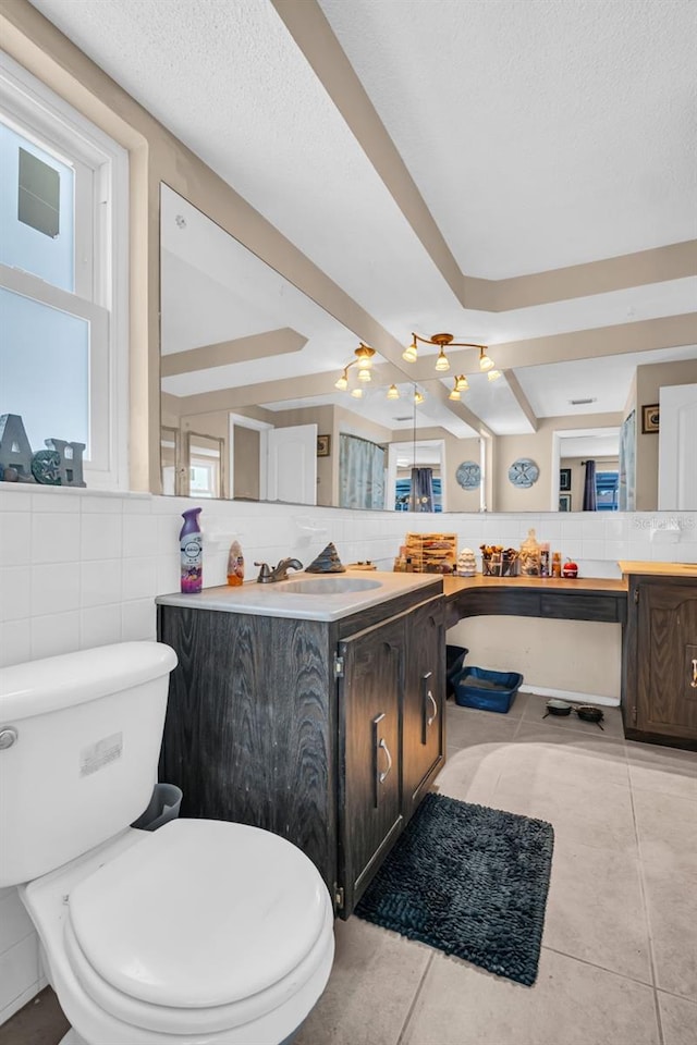 bathroom with tile walls, toilet, tile patterned floors, decorative backsplash, and vanity