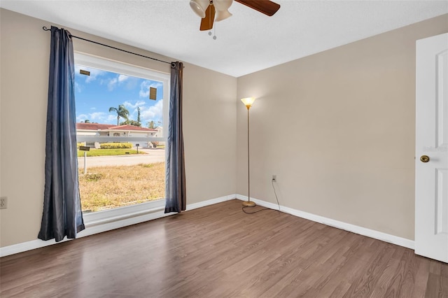 empty room featuring ceiling fan and hardwood / wood-style flooring