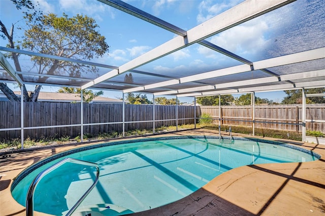 view of pool with a lanai and a patio area