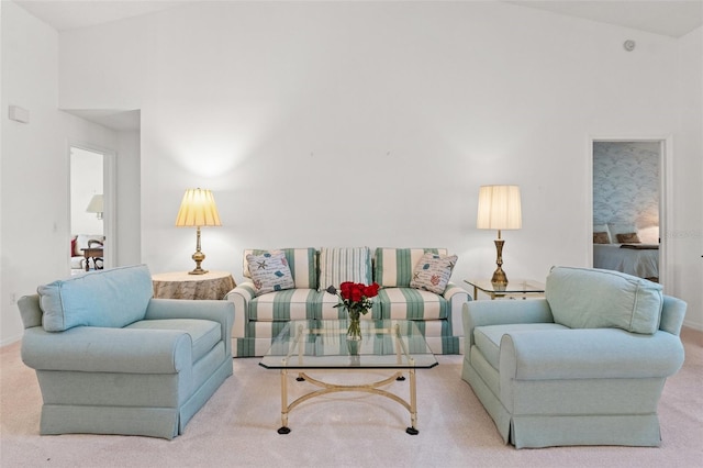 carpeted living room featuring vaulted ceiling