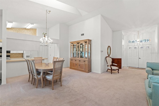 carpeted dining room with high vaulted ceiling and a chandelier