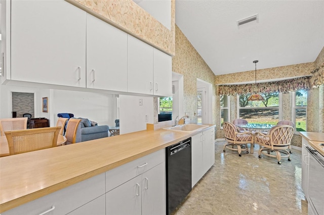 kitchen featuring vaulted ceiling, pendant lighting, sink, white cabinetry, and black dishwasher