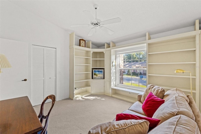 carpeted living room featuring ceiling fan and lofted ceiling