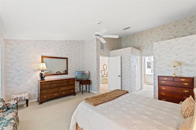 carpeted bedroom with ceiling fan, connected bathroom, and lofted ceiling