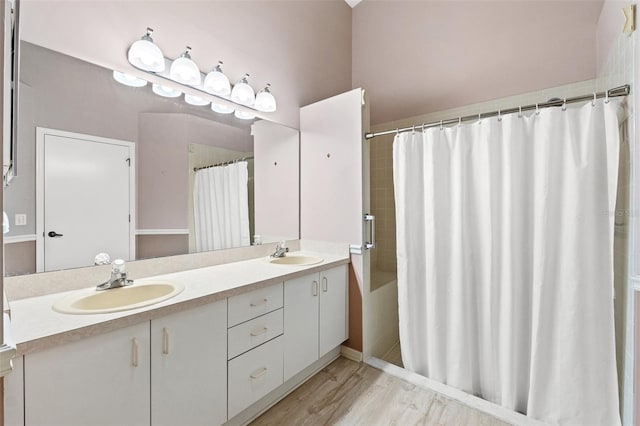 bathroom featuring walk in shower, vanity, and hardwood / wood-style flooring