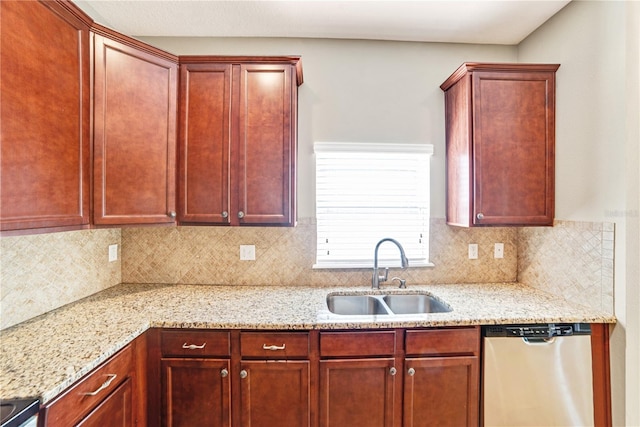 kitchen featuring stainless steel dishwasher, backsplash, light stone countertops, and sink