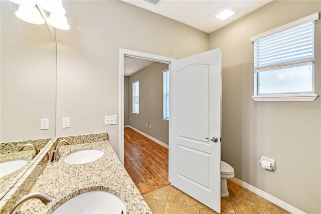 bathroom featuring toilet, vanity, and tile patterned floors