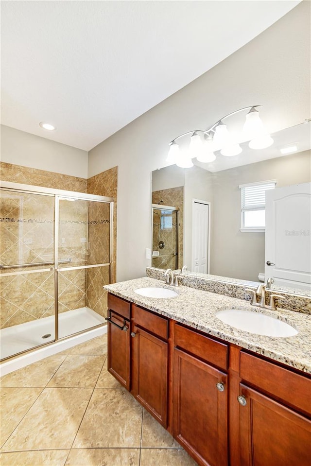 bathroom featuring tile patterned floors, vanity, and walk in shower