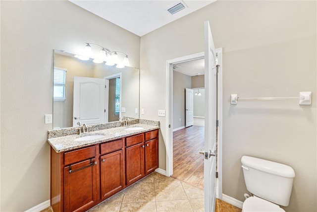 bathroom featuring tile patterned floors, vanity, and toilet