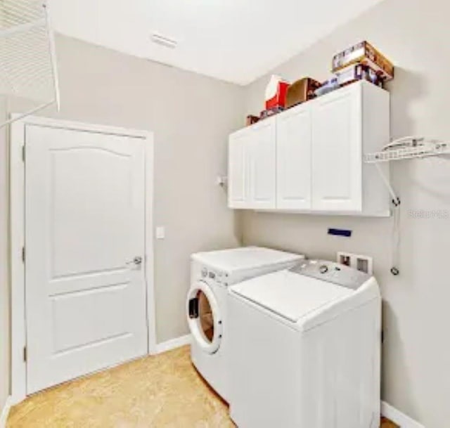 laundry area featuring cabinets and independent washer and dryer