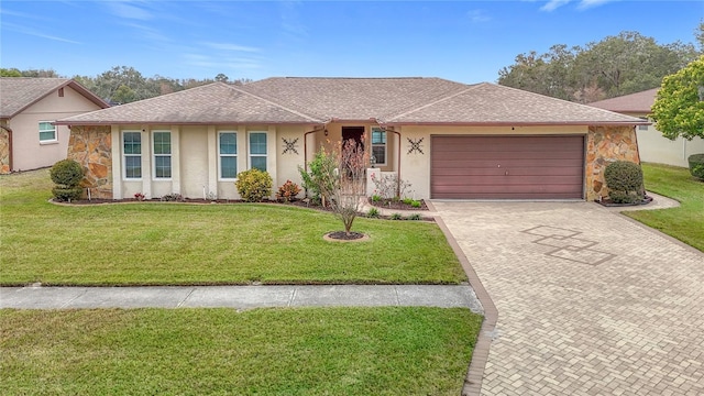 ranch-style home featuring a front lawn and a garage