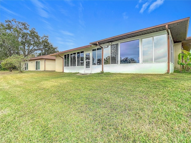 rear view of property with a lawn