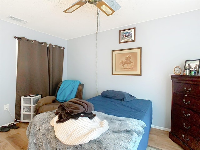 bedroom with ceiling fan and light hardwood / wood-style floors