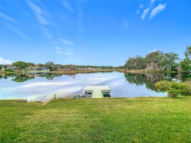 view of dock featuring a yard and a water view