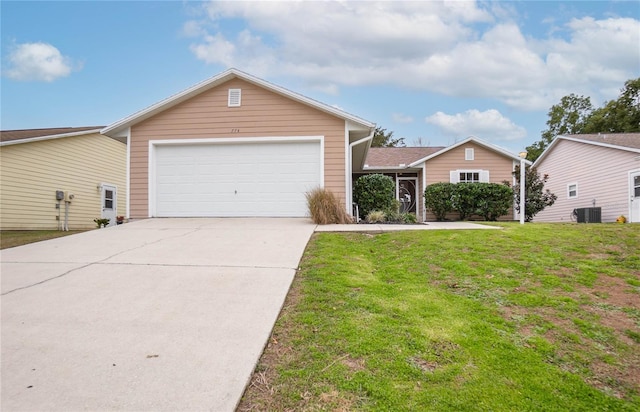 view of front of home featuring a garage, a front yard, and central AC unit