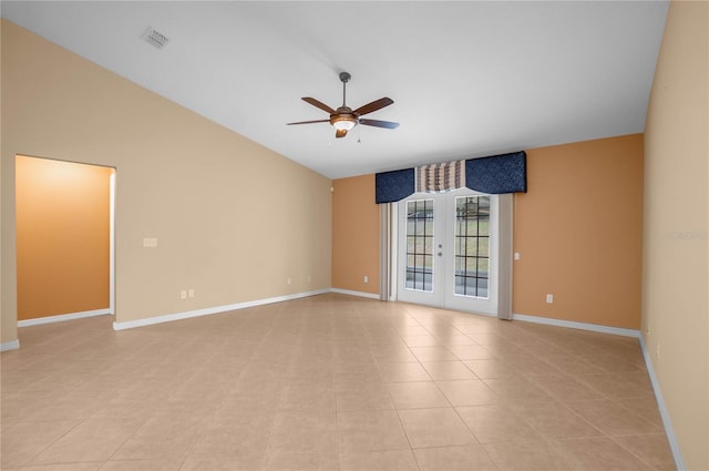 tiled spare room featuring ceiling fan, french doors, and vaulted ceiling