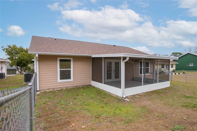 back of house with cooling unit, a yard, and a sunroom