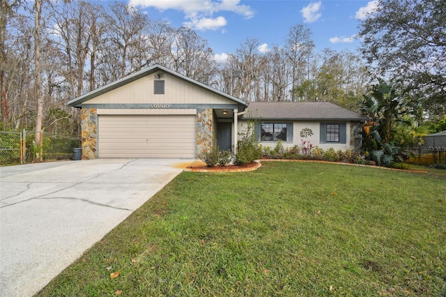 single story home with a garage and a front lawn