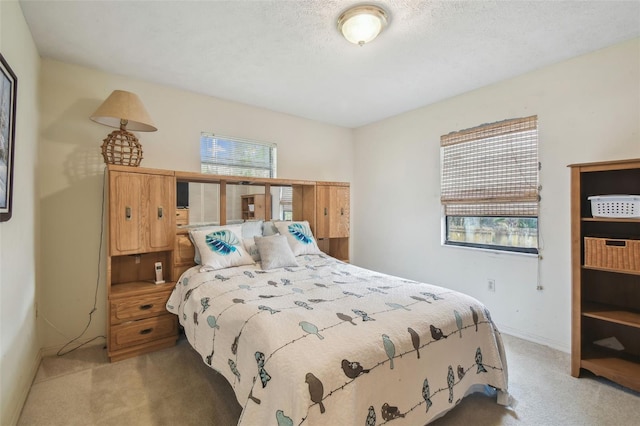 carpeted bedroom featuring a textured ceiling