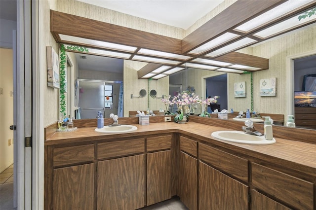 bathroom with walk in shower, vanity, and tile patterned floors