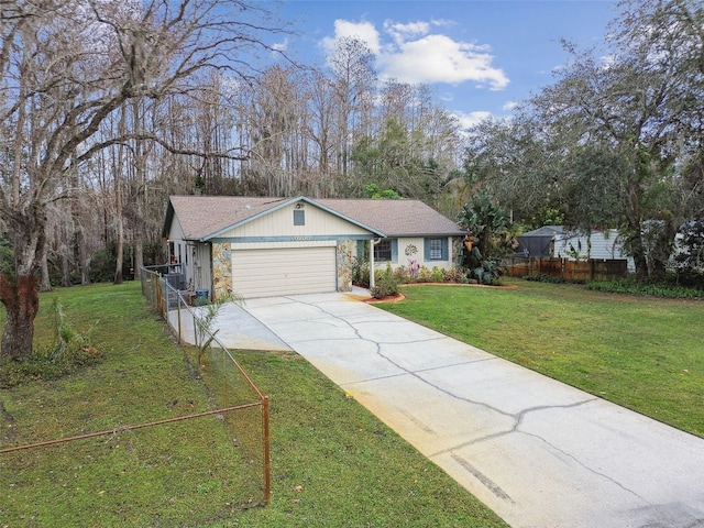 single story home featuring a garage and a front yard