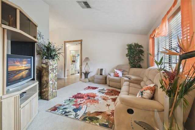 living room featuring light colored carpet and lofted ceiling