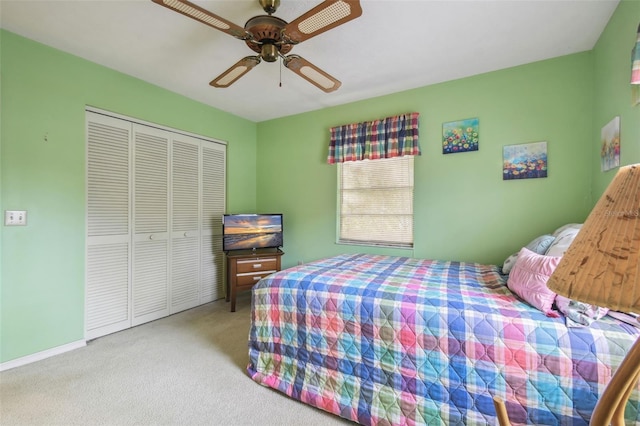 bedroom with ceiling fan, a closet, and light carpet