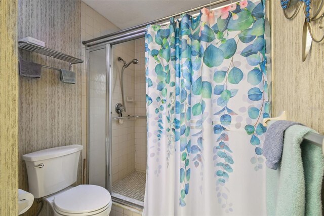 bathroom with walk in shower and toilet