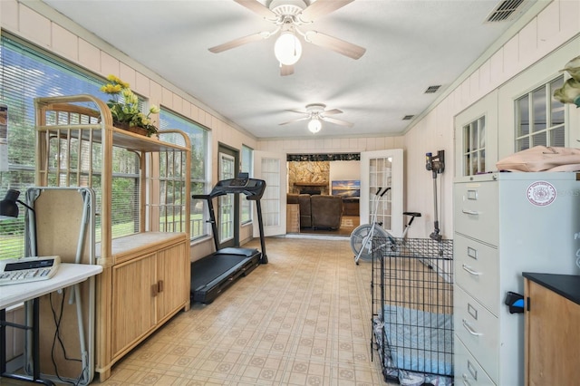 exercise room featuring crown molding and ceiling fan