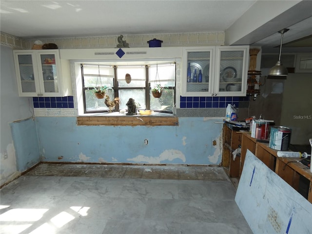 kitchen with white cabinetry and glass insert cabinets