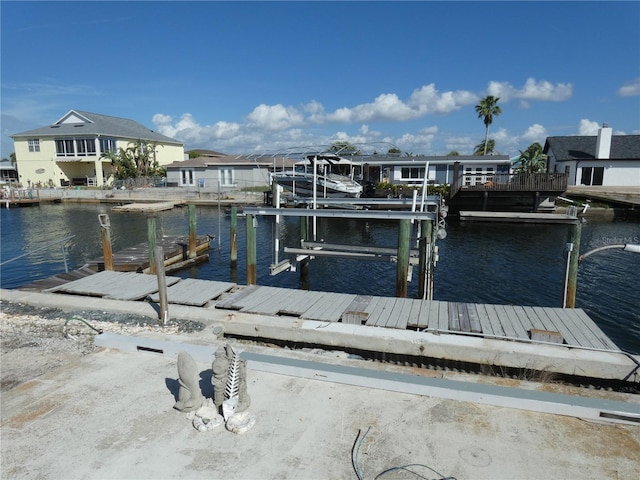 view of dock featuring boat lift and a water view