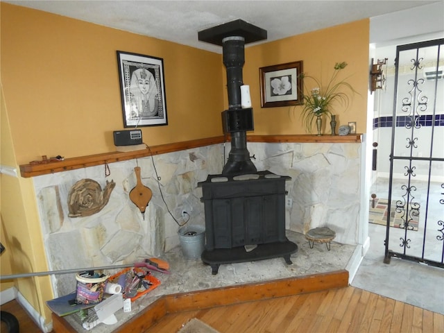 details featuring wood finished floors and a wood stove