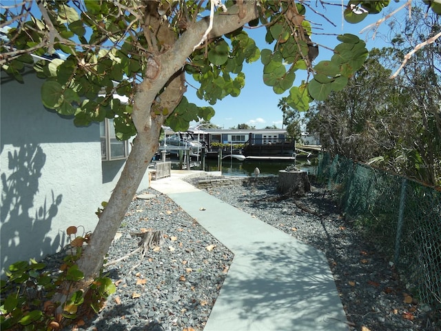 view of yard with fence and a boat dock