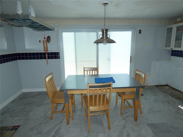 dining area featuring baseboards