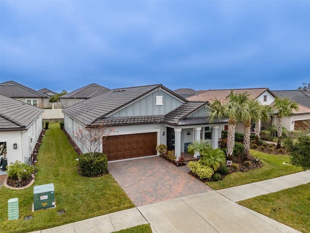 view of front of property featuring a garage and a front lawn