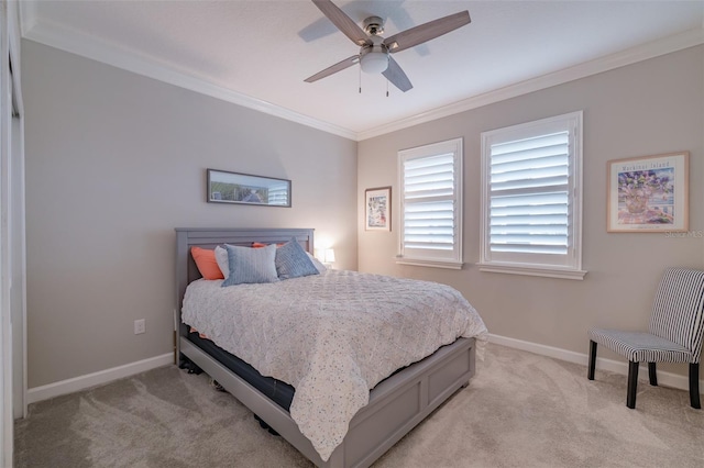 carpeted bedroom with ceiling fan and ornamental molding