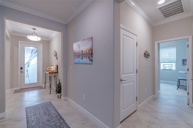 tiled foyer entrance featuring ornamental molding and a healthy amount of sunlight