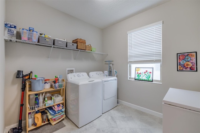 washroom featuring washer and clothes dryer and a healthy amount of sunlight