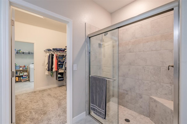 bathroom with walk in shower and washer / clothes dryer